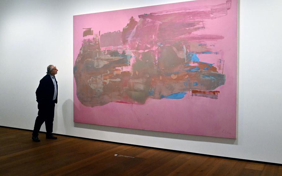 At a museum, a visitor looks at art.