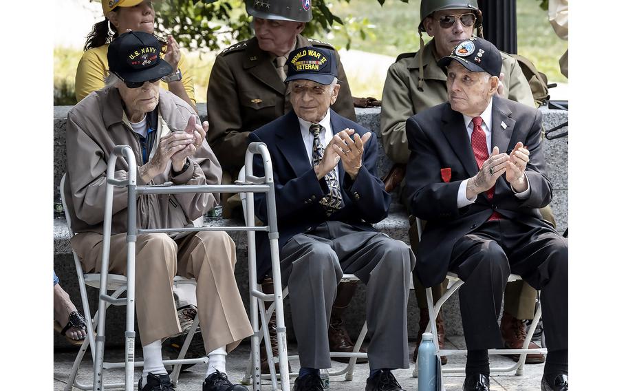 World War II veterans Dixon Hemphill, Frank Cohn and Lincoln Harner, left to right, applaud during a ceremony at the National World War II Memorial in Washington, D.C., on the 79th anniversary of the start of the D-Day invasion, Tuesday, June 6, 2023.