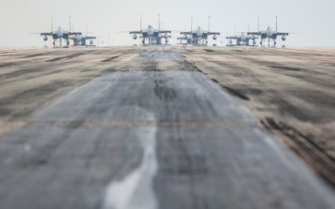 A formation of F-15 Eagles, a KC-135 Stratotanker, an E-3 Sentry and an HH-60 Pavehawk taxis down the runway at Kadena Air Base, Okinawa, Wednesday, March 2, 2022.