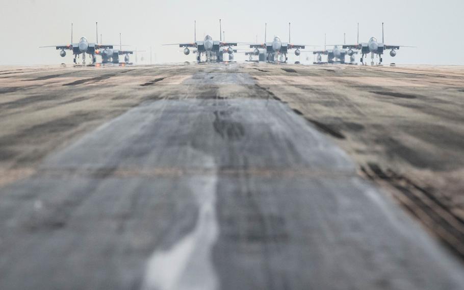 A formation of F-15 Eagles, a KC-135 Stratotanker, an E-3 Sentry and an HH-60 Pavehawk taxis down the runway at Kadena Air Base, Okinawa, Wednesday, March 2, 2022.