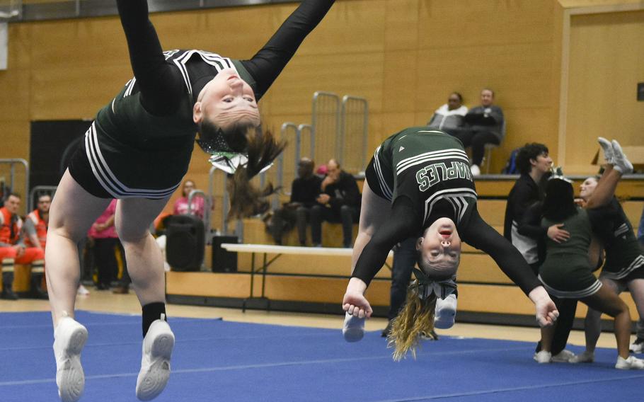 Naples cheerleaders perform synchronized backflips during the 2024 DODEA-Europe Cheerleading Championships in Wiesbaden, Germany on Friday, Feb. 16, 2024. Naples claimed the Division II champion title during the competition. 