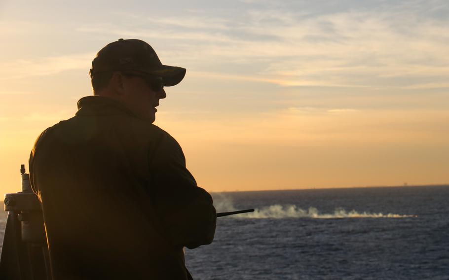 Cmdr. Brad Fancher, commanding officer of the USS Carter Hall, scans the balloon's debris field Feb. 4, 2023. 