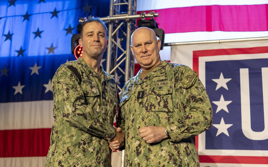 Cmdr. James Kotora,  receives a Meritorious Service Medal from Adm. Christopher W. Grady