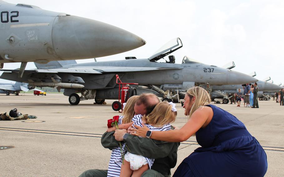 Cmdr. Jaime Moreno dropped to the ground to wrap his arms around his two daughters, 4-year-old Anna and 2-year-old Olivia, as his wife and their mother Lynn Moreno kneeled at their sides.