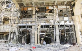 An army soldier walks in front of the damaged Republican Palace in Khartoum, Sudan, after it was taken over by Sudan's army Friday, March 21, 2025. (AP Photo)