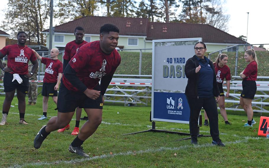 Soldiers take turns running the 40-yard dash at the NFL Salute to Service boot camp in Vilseck, Germany, on Nov. 9, 2022. 