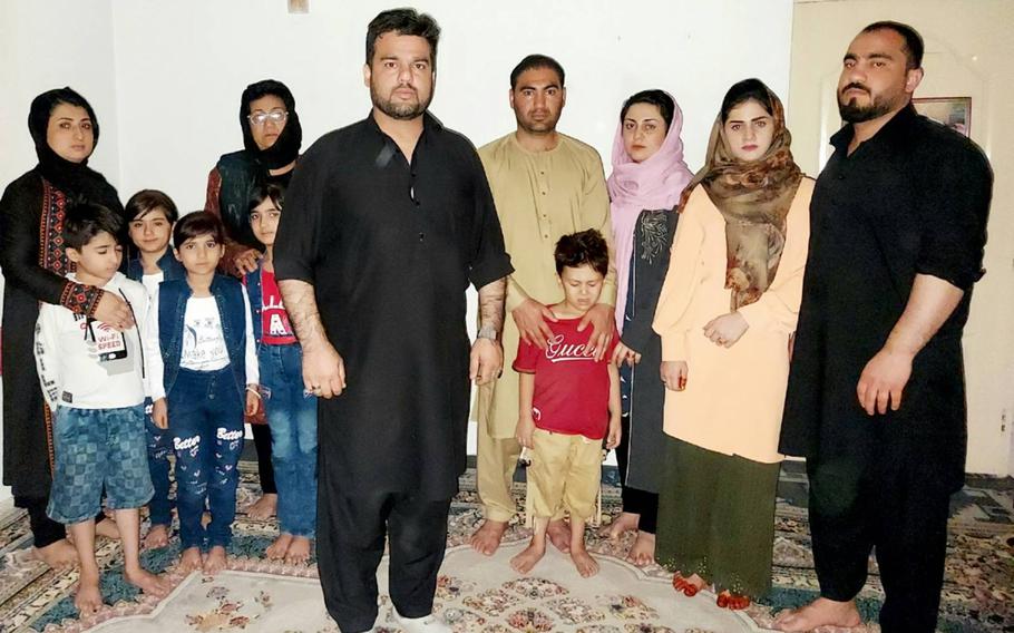 Rahim Rauffi and his family in hiding in Kabul in September 2021, only days after Afghanistan fell to the Taliban. The photo was taken to help U.S. military forces identify them should they be chosen for a military-led escape. 