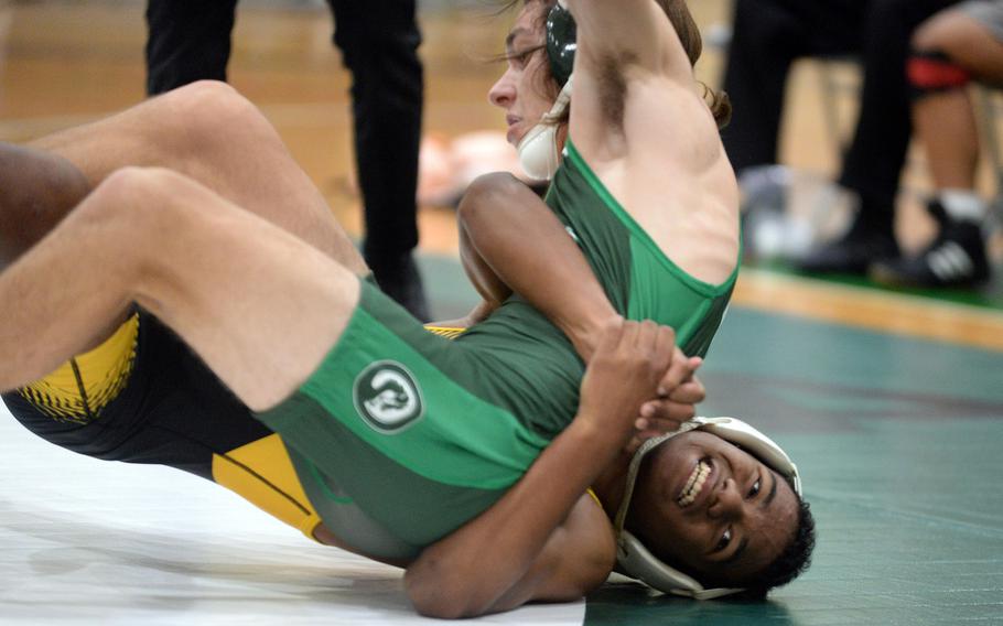 Kadena's James Kinney uses a gut wrench to turn Kubasaki's Max Lundberg at 148 pounds during Wednesday's Okinawa wrestling dual meet. Kinney won by technical fall 11-0 in 2 minutes, 54 seconds, and the Panthers won the meet 30-27.