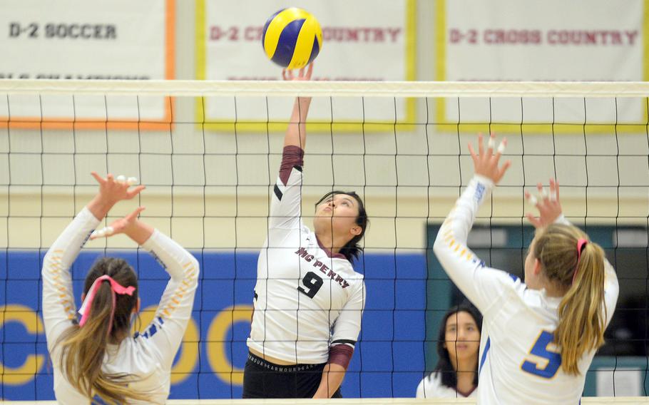 Matthew C. Perry's Jessica Griffin spikes between Yokota's McKayla Clouse and Charlotte Rhyne during Friday's DODEA-Japan volleyball match. The Panthers won in four sets.