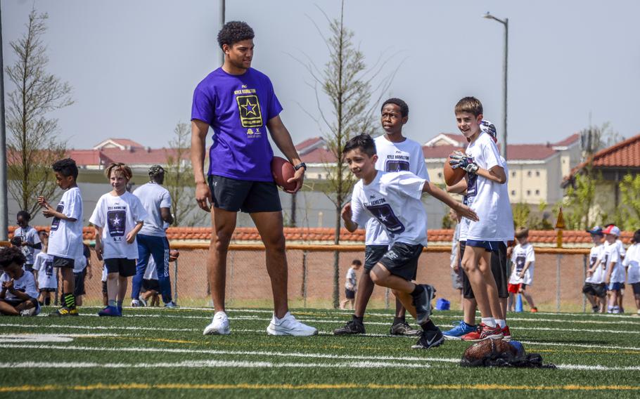 Baltimore Ravens strong safety Kyle Hamilton provides pro tips to young players at Camp Humphreys, South Korea, April 13, 2024.