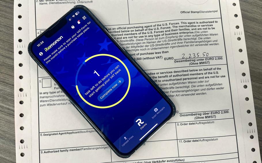 An image of the Remonon app on a cell phone resting on a form for reimbursement.