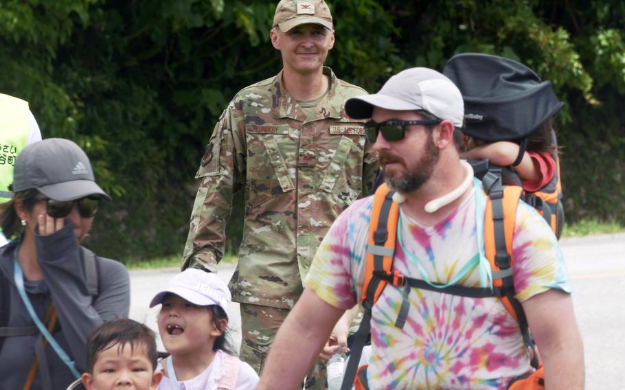 Air Force Col. Joshua Lundeby, deputy commander of 18th Wing, accompanies volunteers as they rehearse a tsunami evacuation at Kadena Air Base, Okinawa, Saturday, Sept. 16, 2023.