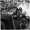 Somewhere in South Korea, April 1958: Using his jeep's side mirror and his helmet as a basin, Spc. Harry W. Wise shaves after a night of guard duty. Wise and his 7th Military Police Company (Prov.) was on a five-day field exercise with the 7th Infantry Division. The Army's first pentomic MP company pulled guard duty and local road patrols not in the regular 7th Inf. Div.'s area, but in the battle-scarred mountains of north-central South Korea, where field exercise Northwind was held. 
The short lived pentomic structure adopted by the U.S. Army between 1957 and 1963 aimed at creating units able to deploy more rapidly than the traditional brigades by combining parts of different units in one comprehensive and cohesive unit, reducing the time needed to organize an attack if different brigades were involved. With nuclear arms entering the battlefield after WWII, the pentomic units would be able to respond quickly before the enemy could respond with a nuclear strike.  

Looking for Stars and Stripes’ historic coverage? Subscribe to Stars and Stripes’ historic newspaper archive! We have digitized our 1948-1999 European and Pacific editions, as well as several of our WWII editions and made them available online through https://starsandstripes.newspaperarchive.com/

META TAGS: Pacific; South Korea; 7th Infantry Division; U.S. Army; Military Police; MP; pentomic; training; exercise;