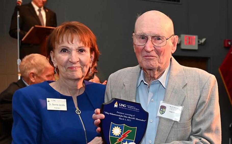 Merrill's Marauder veteran Gabriel Kinney receives a commemorative plaque from University of North Georgia President Bonita Jacobs during the March 3, 2022, premiere of the documentary film, "They Volunteered for This: Merrill's Marauders."