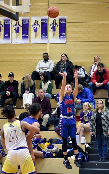 Ramstein's Timar Dix puts up a shot in the second quarter during Thursday's game at Wiesbaden High School in Wiesbaden, Germany. Defending in the low block is the Warriors' Nigel Rodriquez.