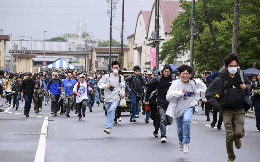 Visitors run into Yokota Air Base in western Tokyo for the 47th annual Friendship Festival, Saturday, May 20, 2023.