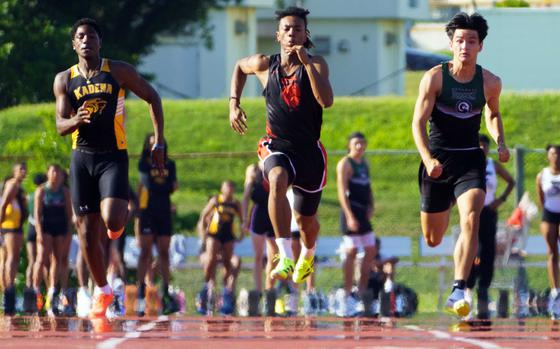 OCSI's Jeremiah Tucker, middle, ran the 100 in 10.45 seconds, a Pacific record. Flanking him are Kadena's Carmelo Ward (10.60) and Kubasaki's Ryan Hater (10.59).