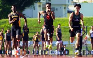OCSI's Jeremiah Tucker, center, now holds the Pacific record in the 100 at 10.45 seconds.