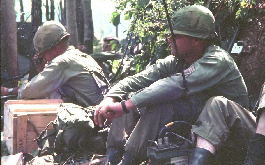 Lt. Col. Hal Moore and Sgt. Maj. Basil L. Plumley sit at the “termite mound,” also known as the command post.﻿ 