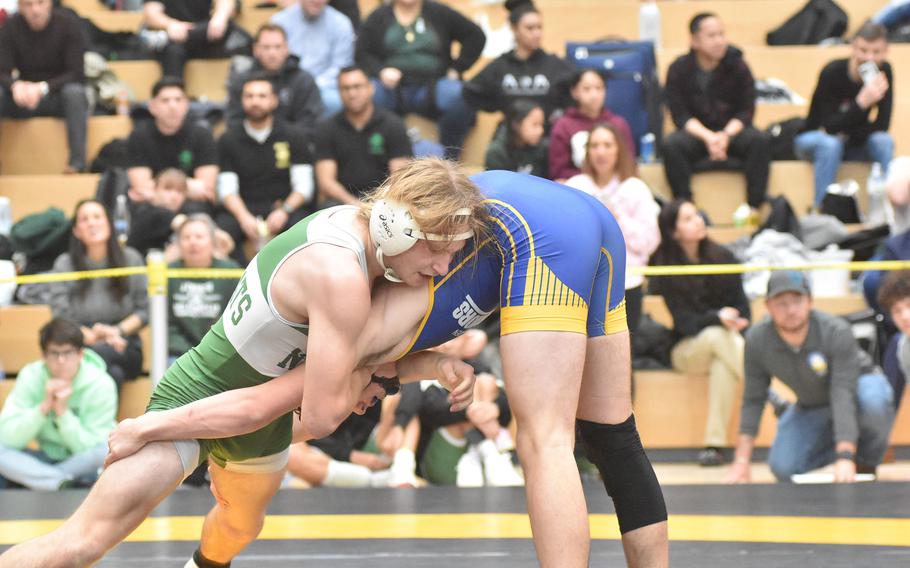 Naples’ Brady Price tries to gain control over Wiesbaden’s Elam Dunton a 138-pound  semifinal at the DODEA European Wrestling Championships on Saturday, Feb. 10, 2024. But Dunton went on a 12-7 victory.