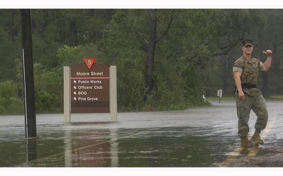 A video screen grab shows a Marine standing on a road overflow with rainwater from Hurricane Irma at Marine Corps Air Station Beaufort, S.C., on Sept. 11, 2017. 