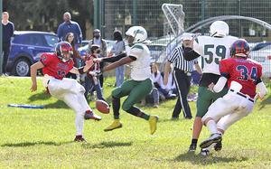 Naples Wildcats' Marcus Wilson blocks a punt by Aviano Saints Julian Riley during Saturday's football game held at Aviano. After the block, Wilson recovered the ball inside the end zone for a Wildcats touchdown. The Wildcats won the game decisively by the score of 40-0. 