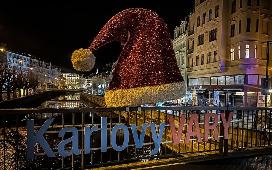 A Santa hat decorates a footbridge over the Tepla River in Karlovy Vary, Czech Republic. The location is a popular photo stop for visitors to the Bohemian spa town during the winter holiday season.