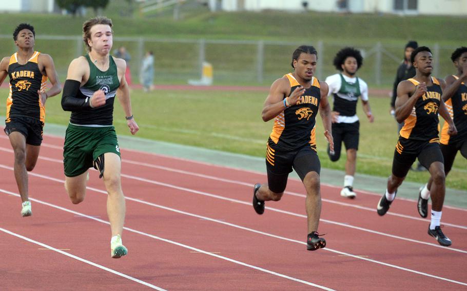 Kubasaki's Caleb Stephan (in green) leads the pack down the stretch in the 200 during Wednesday's first day of a two-day DODEA-Okinawa track and field meet. Stephan won in 22.74 seconds.