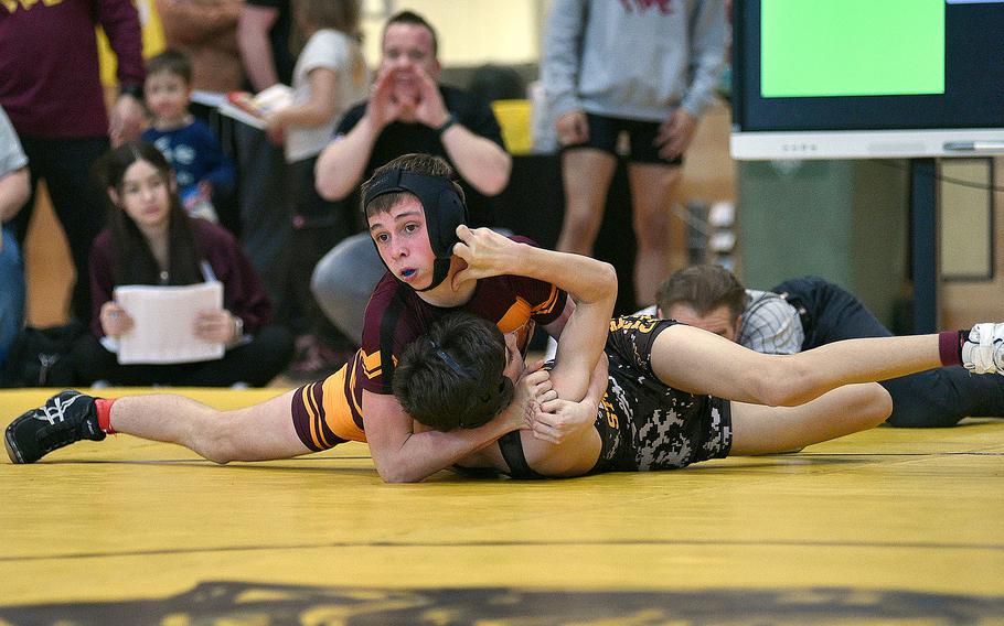 Vilseck’s Johnathan Wissemann holds Stuttgart’s Dominick Welsh against the ground during the 113-pound final during a DODEA wrestling sectional meet on Feb. 3, 2024, at Stuttgart High School in Stuttgart, Germany.