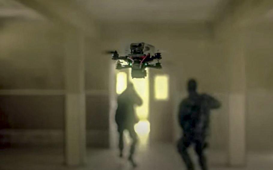 A video screen grab shows a stealthy drone approaching enemy forces from behind.