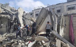Palestinians survey destroyed buildings after an Israeli airstrike in Rafah, Gaza Strip, on April 29, 2024.