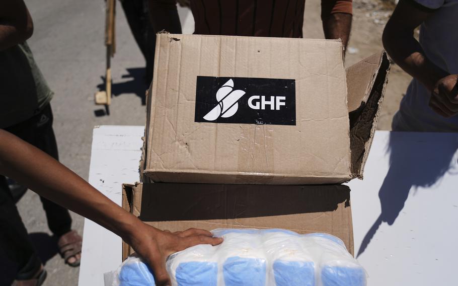 Boxes and bags of aid marked GHF.