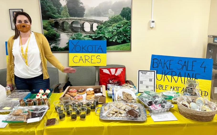 Air Force spouse Joanna Storms, 37, a native of Lublin, Poland, raises money for Ukrainians through a bake sale at Yokota Air Base, Japan, March 9, 2022.  