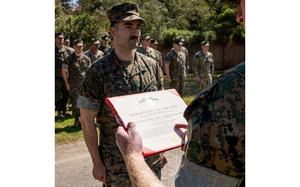U.S. Marine Corps Gunnery Sgt. Benjamin Frazier, an intel instructor with Marine Corps Detachment Dam Neck, Virginia, receives the Navy and Marine Corps Commendation Medal for saving the life of a fellow Marine at Naval Air Station Dam Neck, Virginia, March 21, 2024. Since December 6, 1941, this medal has been awarded to Sailors and Marines that have distinguished themselves through heroic or meritorious service. (U.S. Marine Corps photo by Sgt. Hannah Adams)