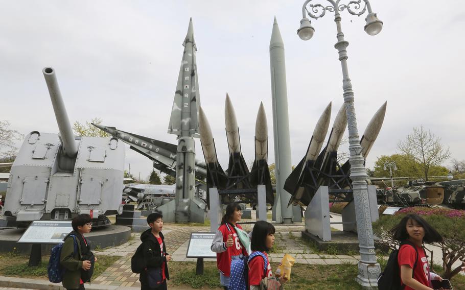 Elementary school students pass by mock South and North Korean missiles at Korea War Memorial Museum in Seoul, South Korea, April 18, 2019. 
