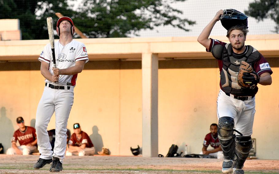 Stuttgart batter Dustin Ward, left, looks up after hitting a foul ball while Heidenheim catcher Kilian Redle, right, goes after the ball during a June 9, 2023, Baseball Bundesliga game at TVC Ballpark in Stuttgart, Germany. The Heidekoepfe defeated the Reds, 9-7.