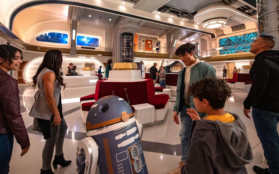 Guests are greeted by a droid in this promotional photo for the Star Wars: Galactic Starcruiser hotel at Walt Disney World in Florida. The hotel will close in the fall, less than two years after it opened. 