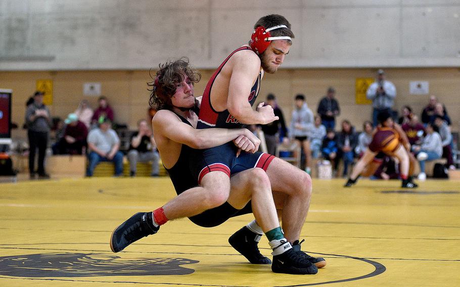 Baumholder's Gabe Dubay brings Kaiserslautern's Harlan McKee to the ground during a 157-pound match during a DODEA-Europe wrestling sectional meet on Feb. 3, 2024, at Stuttgart High School in Stuttgart, Germany.