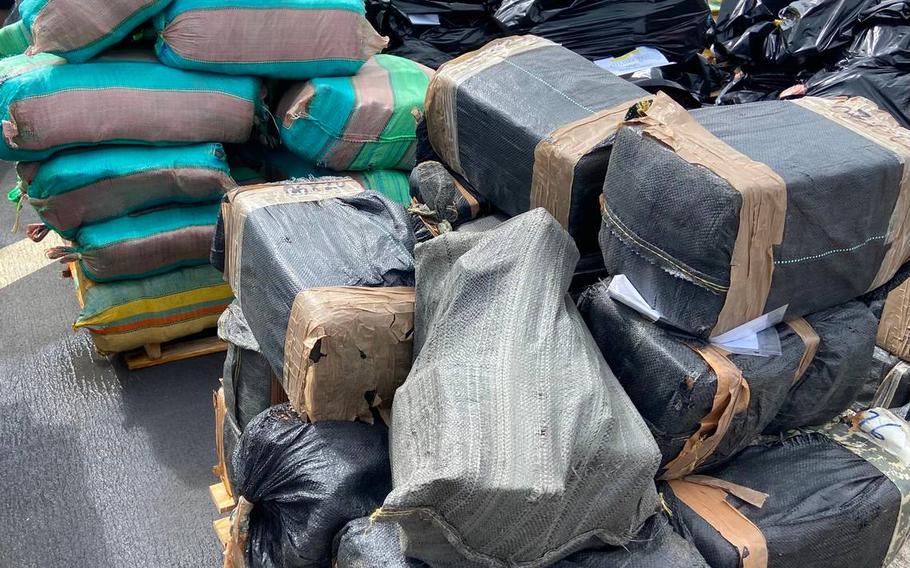 Packages of cocaine and marijuana are stacked on the deck of the U.S. Coast Guard Cutter James Thursday, Feb. 17, 2022.