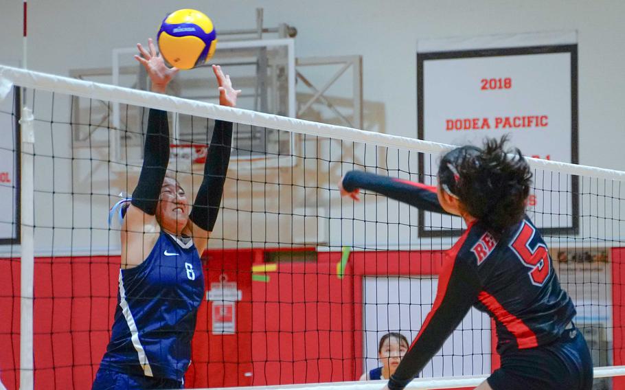 Layla Alvarez spikes through a block.
