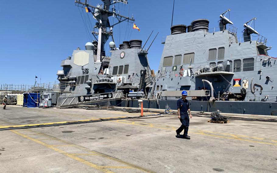 A sailor walks past the USS Roosevelt, one of four destroyers homeported at Naval Station Rota in Spain, in August 2022. The base recently stepped up security after several letter bombs were sent to government officials and buildings in Spain, including the U.S. Embassy in Madrid. 