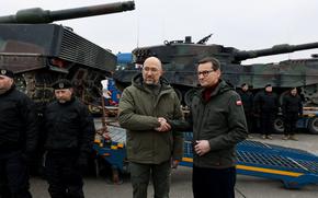 Polish Prime Minister Mateusz Morawiecki greets Ukrainian Prime Minister Denys Shmyhal during the delivery of the first Polish Leopard 2A4 main battle tank to Ukraine in February 2023. Poland this week said it will no longer supply its weapons to Ukraine.