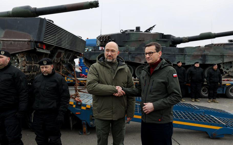 Polish Prime Minister Mateusz Morawiecki greets Ukrainian Prime Minister Denys Shmyhal during the delivery of the first Polish Leopard 2A4 main battle tank to Ukraine in February. Poland said this week that it will no longer supply its weapons to Ukraine.