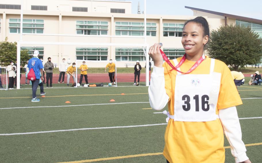 Yokota High School student Daisy Elliott shows the medal she won in the 50-meter run during the Kanto Plains Special Olympics at Yokota Air Base, Japan, Saturday, Nov. 5, 2022.