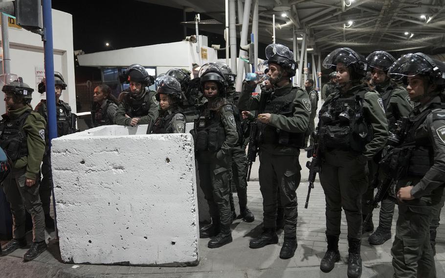 Israeli border police officers gather at the scene of an alleged stabbing attack at Shuafat crossing in east Jerusalem, Monday, Feb. 13, 2023.