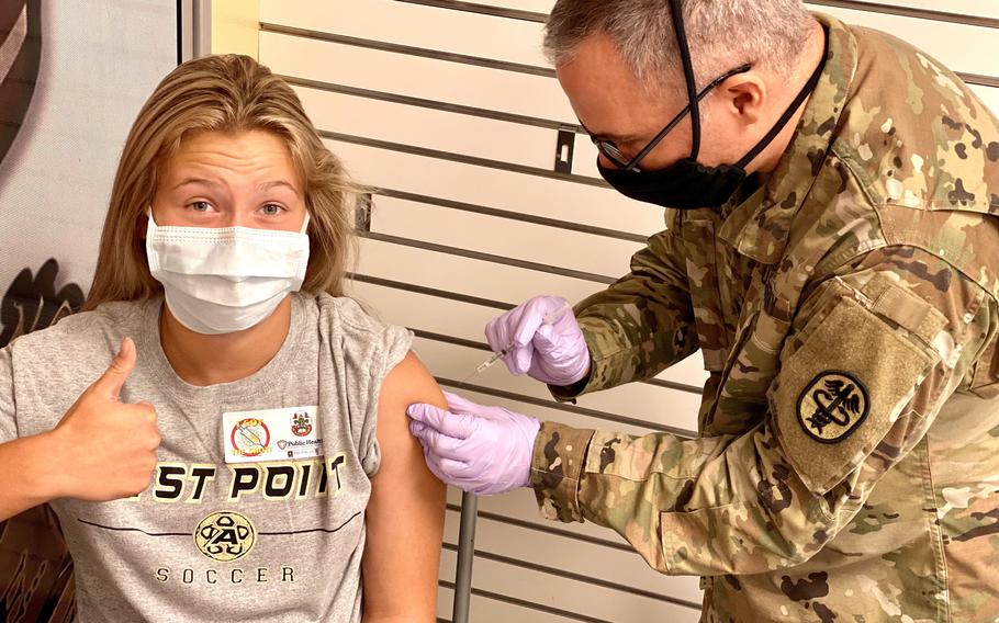 Spc. Steven Blackburn administers the Pfizer COVID-19 vaccine to Oliva Chapman, 13, at Fort Polk, La., on July 24, 2021. The military is stocking up on Pfizer’s pediatric COVID-19 vaccine in preparation for pending approval to use it for children ages 5 to 11.