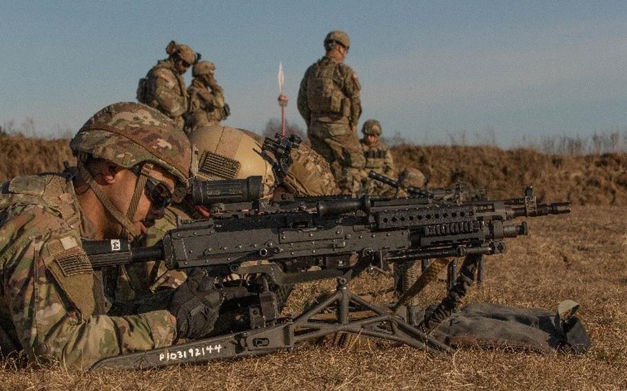 U.S. soldiers assigned to 1st Battalion, 185th Infantry zero their weapons at Bemowo Piskie Training Area, Poland, on March 11, 2022.  The U.S. has roughly 8,750 troops in Poland. Those troops will remain there to help defend the NATO country, a senior U.S. defense official said Monday.