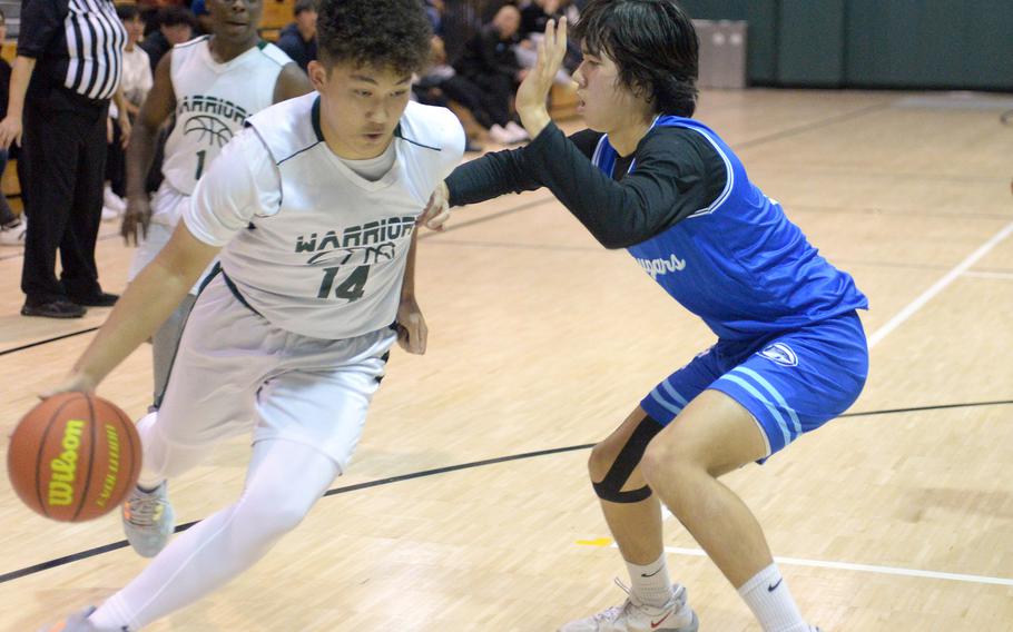 Ex-teammates go at it. Daegu's Andrew Burks, formerly of Osan, is guarded by Cougars' Adam Rutland during Friday's Korea boys basketball game. The Cougars edged the Warrriors 73-70.