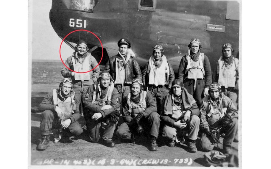 The crew of the WWII aircraft pose with the plane,