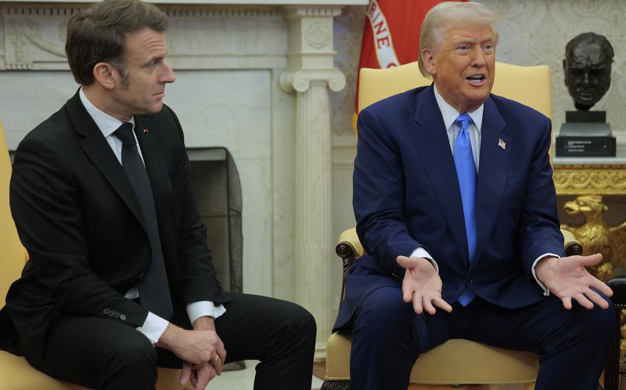 French President Emmanuel Macron looks over at U.S. President Donald Trump as they answer journalists’ questions in the Oval Office. 